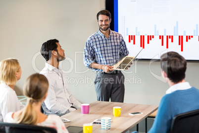 Business people discussing over graph during a meeting