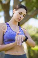 Woman checking time while exercising