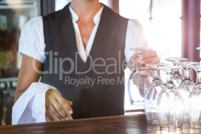 Waitress cleaning glasses