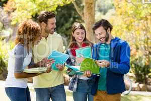 Group of college friends discussing the notes