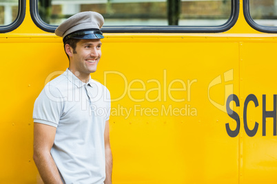 Bus driver smiling in front of bus