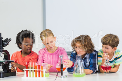 Kids doing a chemical experiment in laboratory