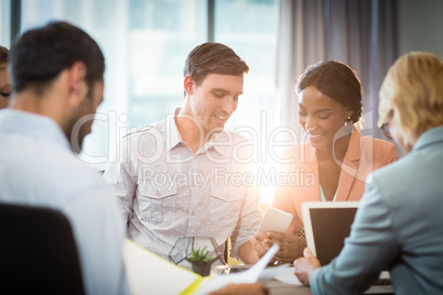 Group of business people interacting at desk
