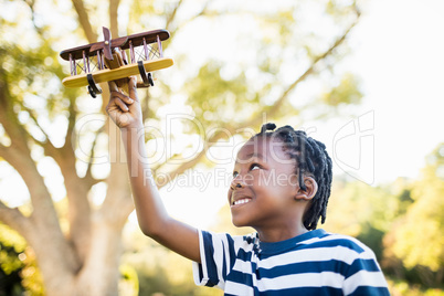 Happy child playing with a plane