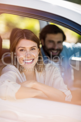 Happy couple sitting in a car