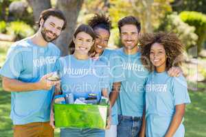 Portrait of volunteer group holding box