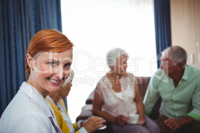 Portrait of a smiling nurse with seniors