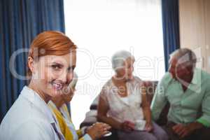 Portrait of a smiling nurse with seniors