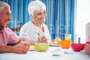 Senior smiling woman during breakfast