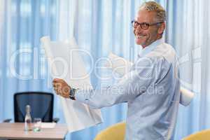 Portrait of man holding blueprint