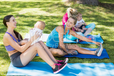 Women holding their babies while exercising