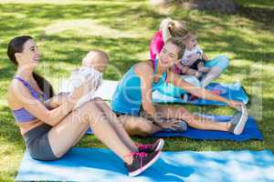 Women holding their babies while exercising