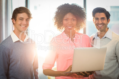 Portrait of business people discussing over laptop Portrait of business people discussing over laptop
