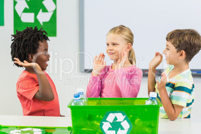 Kids giving high five to each other in classroom