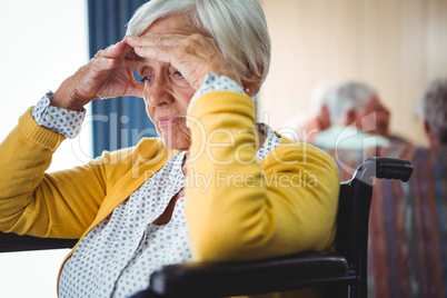 Senior woman in wheelchair look worried