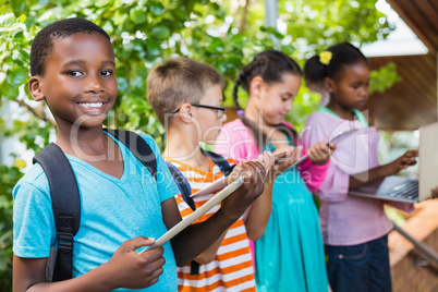 Kids using digital tablet and laptop at school