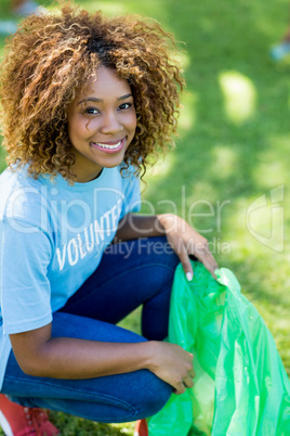 Portrait of volunteer woman collecting rubbish