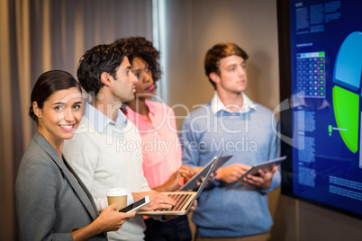 Business people looking at a graph in the conference room