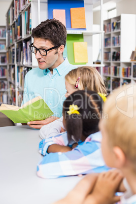 Teacher reading book in library