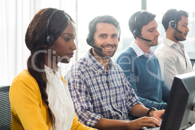 Team working on computer with headset