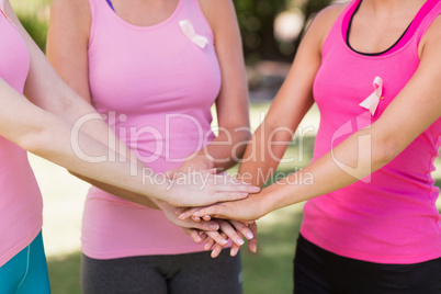 Mid section of volunteer women forming hands stack