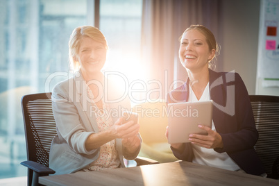 Businesswomen interacting using digital tablet and mobile phone