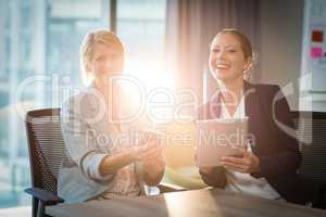 Businesswomen interacting using digital tablet and mobile phone