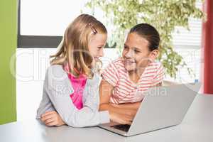 Kids using laptop in library