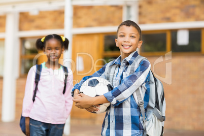 Smiling kids standing in classroom at school