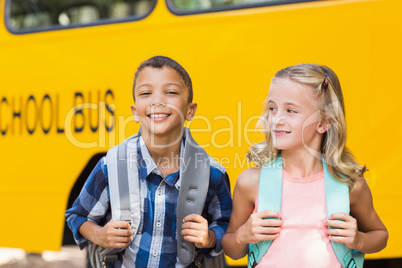 Kids standing in front of school bus