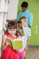 Schoolgirl reading book in library