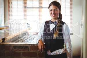 Waitress leaning against counter