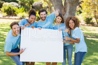 Group of volunteer holding a blank sheet and pointing to it