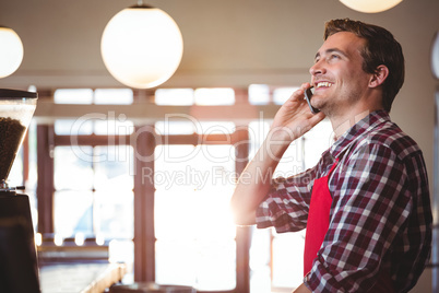 Waiter talking on mobile phone