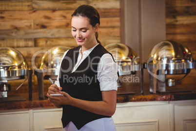 Waitress taking order on a notebook