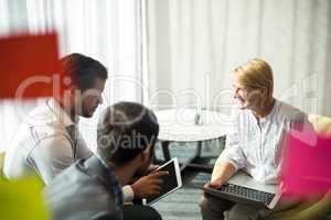 Business people interacting using digital tablet and laptop