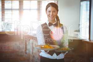 Waitress holding dishes