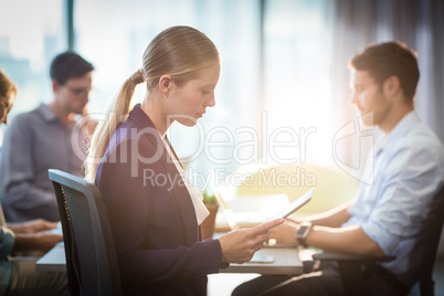 Businesswoman using digital tablet during meeting