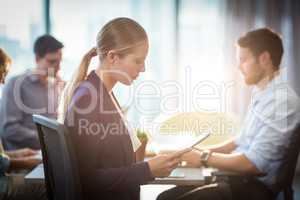 Businesswoman using digital tablet during meeting