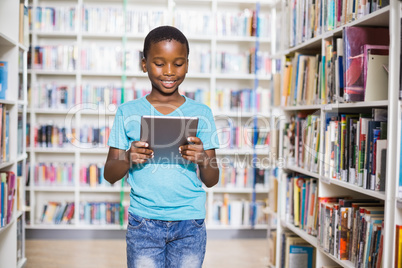 Schoolboy using digital tablet in library Schoolboy using digital tablet in library