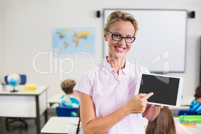 Portrait of teacher pointing at the digital tablet