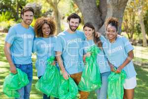 Portrait of volunteer group posing while collecting rubbish