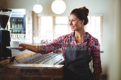 Waitress holding a cup of coffee