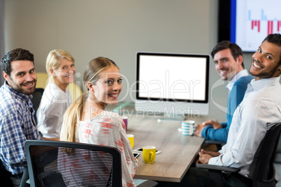 Business people smiling at camera during a video conference