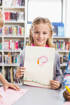 Portrait of schoolgirl showing her drawing