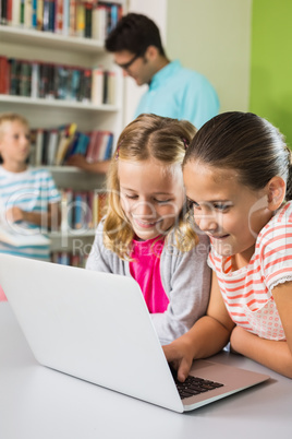 Kids using laptop in library