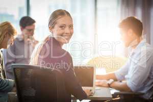 Businesswoman using laptop during meeting