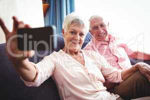 Smiling senior couple taking a selfie