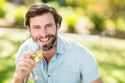 Portrait of man holding wine glass and smiling