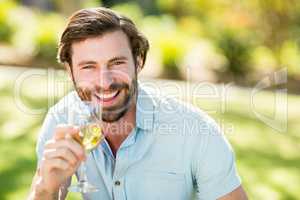 Portrait of man holding wine glass and smiling